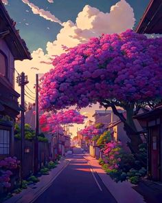 a street lined with houses and trees covered in pink flowers