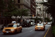 taxi cabs driving down the street in new york city, with words on it