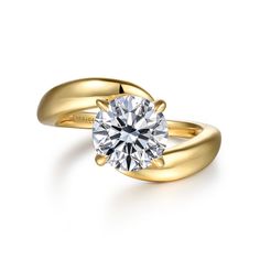 a yellow gold engagement ring with a round diamond