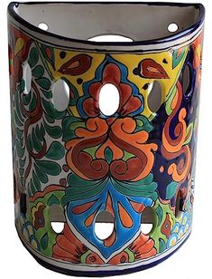 an artisticly painted vase with holes in the middle