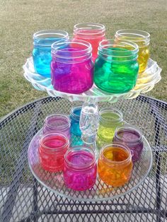 there are many jars that have different colors on them and one is filled with liquid