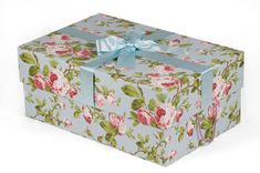 a blue and pink floral box with a bow on the top that has flowers all over it