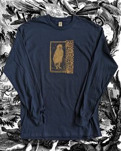 Owlman / Lino-Printed Linocut Orange ink on Long Sleeve Navy shirt. Hand-Printed Handmade Made to Order. Gildan Ultra Cotton Shirt. WASHING TIPS- WAIT 5 DAYS AFTER RECEIVING SHIRT/S BEFORE WASHING- WASH INSIDE-OUT ON FIRST WASH- MAY FADE SLIGHTLY OVER TIME. Inspired by Folk Horror Psychedelia Macabre Fairytales Dark Occult Uncanny Myth Cottagecore Fairycore Goth 90s Skater Trippy Folklore Multicoloured Magick Tarot Folklore British English Lore Owlman Spooky Horror Modern Skate Retro Punk Boho P Long Sleeve Halloween Screen Print Tops, Halloween Long Sleeve Screen Print Tops, Long Sleeve Screen Print Tops For Halloween, Relaxed Fit Long Sleeve Shirt For Halloween, Goth 90s, Folk Horror, Cottage Fairy, Fairy Goth, 90s Skater