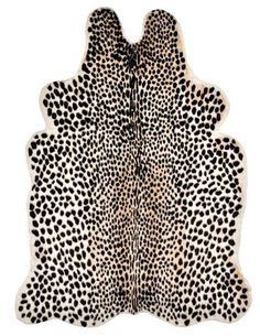 a white and black animal print rug with spots on it's back, in the shape of a cheetah pattern