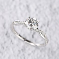 a white gold engagement ring with diamonds on it