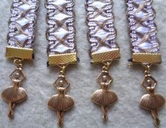 four different types of gold and silver bracelets with beads on them, one in the shape of a ballerina