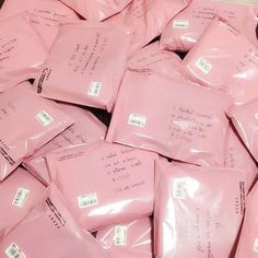 a pile of pink envelopes sitting on top of each other