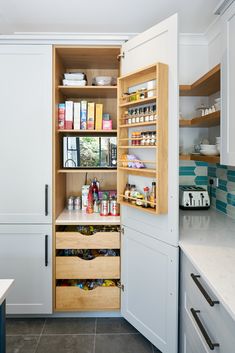 an open pantry with lots of items in the cupboards and on the countertop