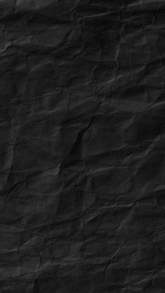 a black paper textured background with some folds