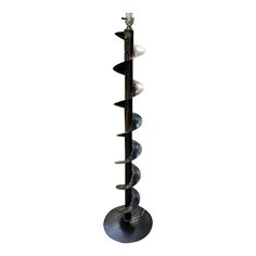 a tall metal pole with spikes sticking out of it's sides on a white background