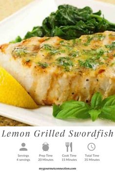 grilled swordfish with lemon and basil butter on a white plate next to a lemon wedge