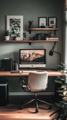 a desktop computer sitting on top of a wooden desk next to a plant and bookshelf