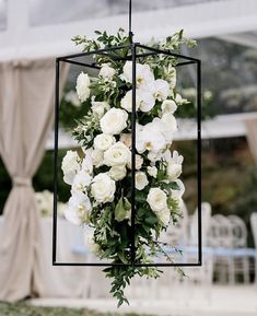 a bunch of white flowers hanging from a pole