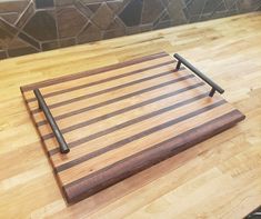 a wooden cutting board sitting on top of a table