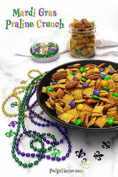 mardi gras snack mix in a black bowl with beads and candy on the side