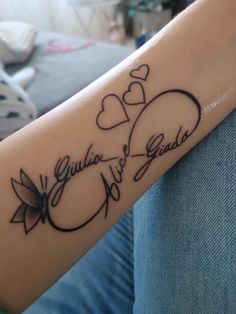 a woman's arm with two hearts and the words grandma and grandad on it