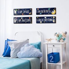 a bed room with a neatly made bed and two signs on the wall above it