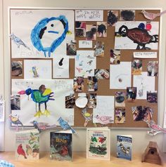 a bulletin board with pictures and magnets on it in front of a wooden table