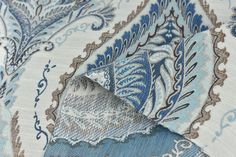 the fabric is blue and white with an intricate design on it's side,