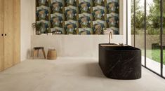 a bath room with a large tub and a wallpapered background on the wall