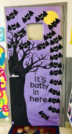 a door decorated to look like it's batty in here with bats on the tree