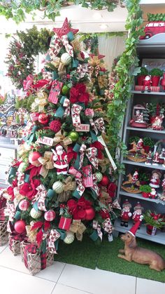 a christmas tree is decorated with bows and ornaments