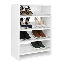 the shoe rack is white and has four pairs of shoes on top of each shelf