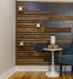 a chair and table in front of a wall with wooden slats on the walls