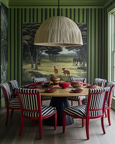 a dining room with green and white striped walls