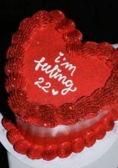 a red heart shaped cake with the words i'm going 25 on it