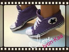 a pair of crocheted shoes with a cat on the side and words love non - kaa written below