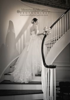 a woman in a wedding dress is walking down the stairs