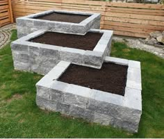 two cinder blocks sitting on top of green grass