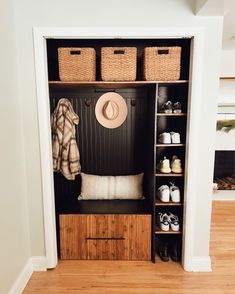 an open closet with shoes and hats in it