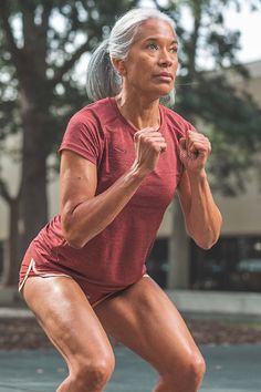 an older woman is running on the street