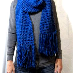 a woman wearing a blue crocheted scarf