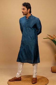 Blue kurta with geometric quilting details in the front. Paired with an off white churidar. - Aza Fashions Indigo Cutdana Kurta For Eid, Indigo Designer Straight Kurta, Indigo Designer Wear Straight Kurta, Designer Indigo Straight Kurta, Indigo Cotton Silk Kurta For Eid, Fitted Indigo Kurta With Chikankari Embroidery, Fitted Blue Chanderi Sherwani, Indigo Cotton Silk Straight Kurta, Fitted Indigo Kurta For Diwali