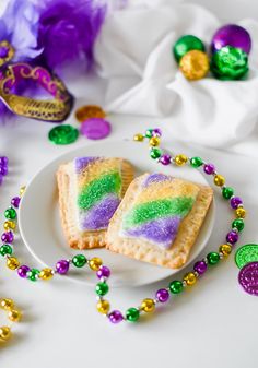 mardi gras pastries on a plate with beads