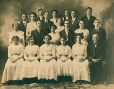 an old black and white photo of a group of people posing for a family portrait