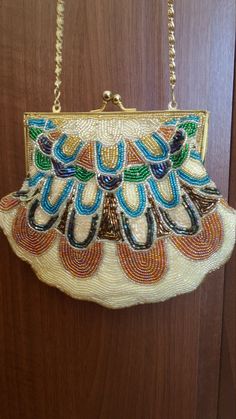 Please Pay Attention that all the photos are personally made by me with my digital camera! Used product, but in excellent out look condition! I will provide tracking number. Please pay attention that I am an international seller! ANTIQUE BEADED PURSE Art Deco Beaded Purse Beautiful Vintage Multi-colored Rainbow Beaded Bag. Vintage condition! Pre-used but no trace of use, no missing beads! Several ends of thread are visible, but this can be easily corrected or hidden.   Super cute woman lady purse in very good condition, unusual shape.  Fully embellished with beautifully colored shimmering beads. Can be carried as a shoulder bag or a clutch if you tuck in the chain shoulder strap. Measures: widest part horizontal -20 cm. In inches - 7.87" small part horizontal where the purse can be locked Gold Beaded Clutch For Everyday Use, Gold Beaded Shoulder Bag As Gift, Gold Beaded Shoulder Bag Gift, Gold Beaded Shoulder Bag For Gift, Elegant Yellow Beaded Bag, Gold Vintage Shoulder Bag, Gold Beaded Rectangular Clutch, Gold Rectangular Evening Bag With Beads, Handmade Gold Handheld Evening Bag