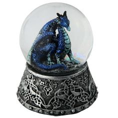 a snow globe with a blue dragon in it