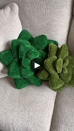 a green flower sitting on top of a white couch