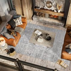 an overhead view of a living room with couches and tables