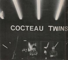 an old photo of two people sitting in front of a storefront with the words coeteau twins on it