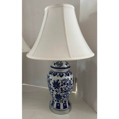 a blue and white lamp sitting on top of a table