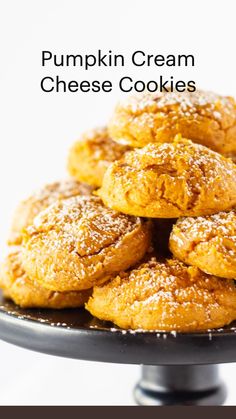 a pile of pumpkin cream cheese cookies on a black platter with the words pumpkin cream cheese cookies