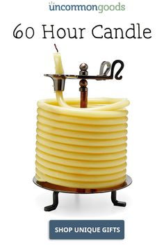 a candle that is on top of a stand with the words, 60 hour candle shop unique gifts