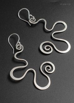 Long Silver Curved Earrings. Handmade sterling silver 925 Earrings with beautiful curves. Length: 7 cm Width: 4,2cm Weight: 7,5 grams for a pair Material: Sterling Silver 925 Texture: Polished Get a 10% discount off your next order by subscribing at Diapiro's newsletter. Link for coupon code https://mailchi.mp/56f529763263/diapiro All of my products are carefully handmade with authentic techniques of Goldsmithing such as Sawing - Forming - Rasping - Sanding - Soldering - Engraving- Hammering - E Elegant Handmade Swirl Earrings, Elegant Hand Forged Swirl Earrings, Elegant Swirl Shaped Hand Forged Earrings, Artistic Hand Forged Sterling Silver Earrings, Modern Twist Silver Jewelry With Ear Wire, Modern Silver Jewelry With Matching Earrings, Modern Twist Silver Jewelry With Matching Earrings, Modern Twist Silver Spiral Earrings, Freeform Sterling Silver Earrings As Gift