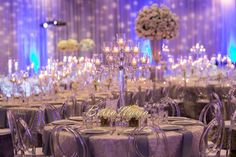 the tables are set with silver linens and crystalware for an elegant wedding reception