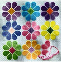 a cross stitch pattern with different colored flowers on the front and side, including one pink ribbon